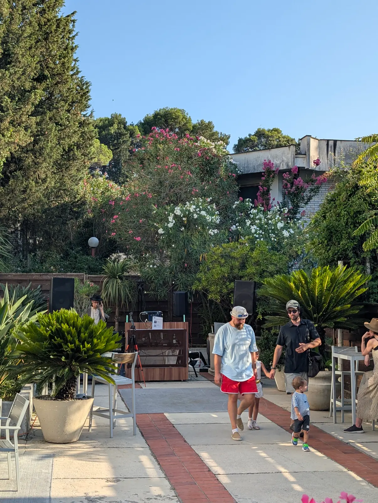 Guests arriving through the studio garden on an Open Day afternoon